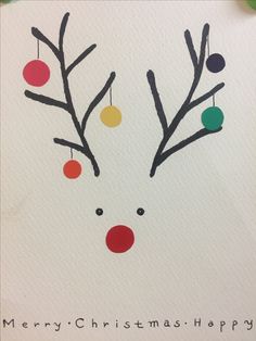 a christmas card with a reindeer's nose and balls on it