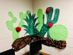 an office cubicle decorated with paper flowers and cacti