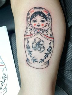 a woman's tattoo with a russian doll on her arm