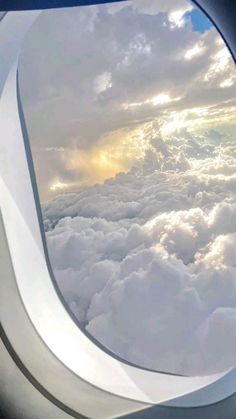 an airplane window looking out at the clouds