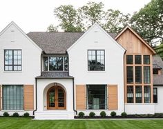 a large white house with brown shutters and windows