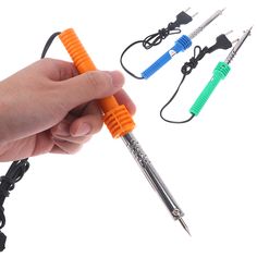 a hand holding an orange and blue pen with four different wires attached to the ends