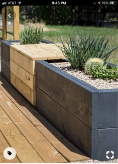 a wooden planter sitting on top of a wooden deck