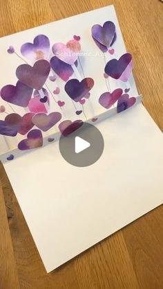 an envelope with hearts cut out of it