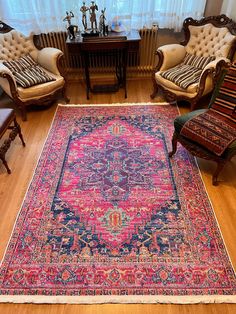 a living room filled with furniture and a large rug