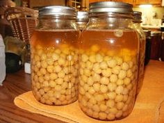 two jars filled with food sitting on top of a wooden table