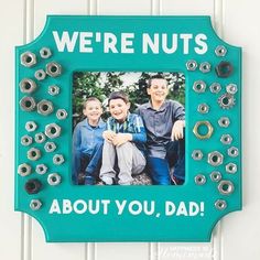 a blue frame with an image of two boys and the words, we're nuts about you, dad