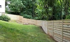 a wooden fence in the middle of a yard