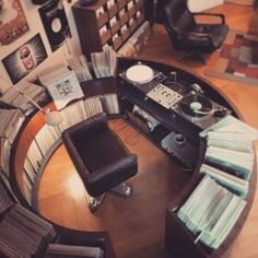 a record player is sitting in the middle of a room with records on the table