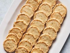 crackers are arranged on a white platter and ready to be served in the oven