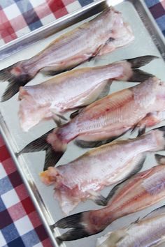 some fish are sitting on a tray and ready to be cooked