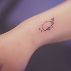 a small elephant tattoo on the left inner arm and wrist, with bubbles coming out of it