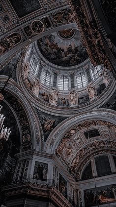 looking up at the ceiling in an ornately decorated building with many windows and statues