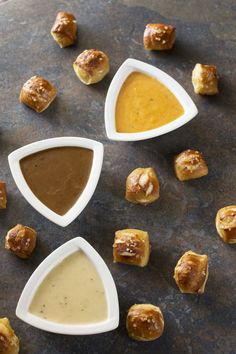 small bowls filled with different types of dips and pastries on top of a table