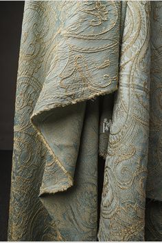 the fabric has been folded up and is very intricately detailed with gold threadwork