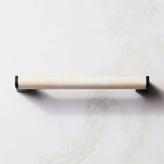 a white and black handle on a marble surface