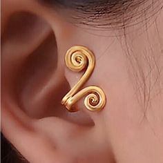 a pair of gold earrings with spiral design