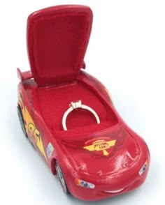 a red toy car with a ring in it