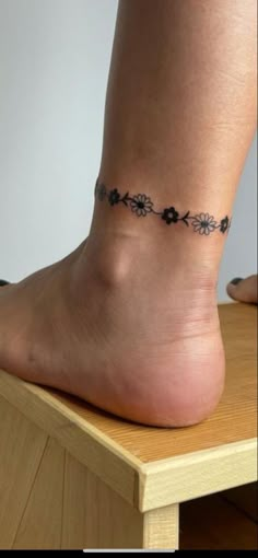 a woman's foot with a tattoo on it