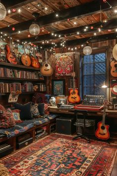 a room filled with lots of musical instruments and bookshelves on the wall above it