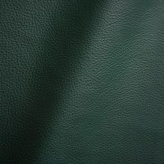 a green leather background with some light shining on it