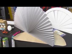 a large fan sitting on top of a table next to other crafting supplies and tools