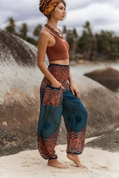 Teal and peach boho trousers with mandala pattern * Made from 100% rayon * Lightweight and comfortable * Elasticated ankles and waistband   * Small Length - 40"/ 100cm Waist - 22"/ 57cm - 44"/ 111cm * Medium/Large Length - 40"/ 101cm Waist - 30"/ 76cm - 53"/134cm * Small fit most UK ladies size 6-10 (US 2-6) * Medium/Large fit most UK ladies 12-16 (US 8-12) Hippie Boho Print Vacation Bottoms, Bohemian Bottoms With Pockets For Vacation, Bohemian Boho Print Pants For Vacation, Boho Print Hippie Pants For Vacation, Hippie Boho Print Pants For Vacation, Boho Print Harem Bottoms For Summer, Vacation Hippie Pants With Boho Print, Summer Boho Print Harem Bottoms, Vacation Boho Print Hippie Pants