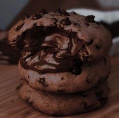 three chocolate cookies stacked on top of each other with melted chocolate in the middle,