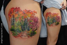 a woman's thigh with colorful trees and leaves painted on the side of her thighs