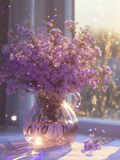 a vase filled with purple flowers sitting on top of a table next to a window