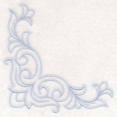 an embroidered design on white paper with swirls and scrolls in the center, as well as