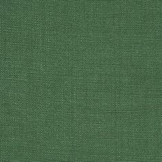 a close up view of a green fabric textured with small dots and lines,