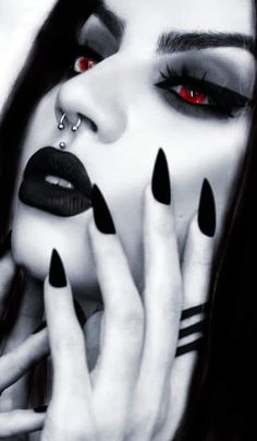 a woman with black nails and red eyes