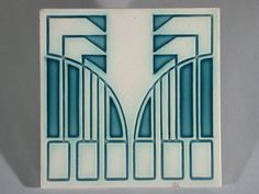 an art deco tile in blue and white