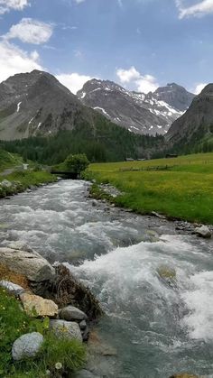 a river running through a lush green valley