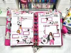 an open planner book sitting on top of a counter next to some scissors and other items