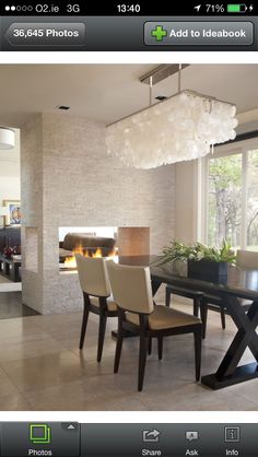 a dining room table with chairs and a fireplace in the background