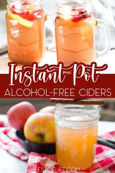 two mason jars filled with apple cider sitting on top of a table