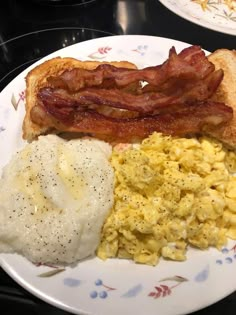 a plate with eggs, bacon and toast on it