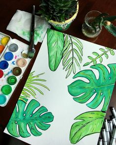 an art project with watercolor paints and plants