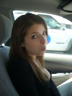 a woman sitting in the back seat of a car