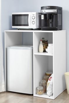 a microwave oven sitting on top of a white shelf