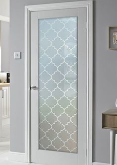 a white door with frosted glass in a room