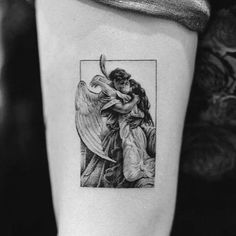 an angel tattoo on the right arm and shoulder, with a woman hugging her child