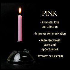 a pink candle sitting on top of a glass bowl