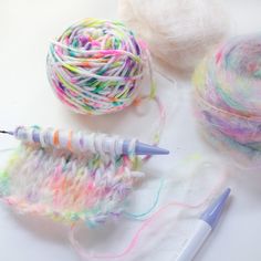 yarn and crochet needles on a white surface