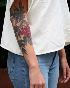 a woman with a flower tattoo on her arm