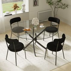 This dining set is a stylish and modern combination of Stainless Steel and tempered glass, making this item a real eye-catcher. The Stainless Steel legs provide strong and sturdy support for the table, whilst the unique intertwined nest design exudes modern style. This table really is capable of being a centerpiece in any home! With a generous surface, you can dine in style with up to many guests. And all of the chairs rest on electroplated metal legs. The contoured curved seats are wrapped in padded teddy fabric, and each can accommodate up to 250 lbs. Ivy Bronx Chair Color: Black | Ivy Bronx 47 Inch Glass Top Pedestal Dining Set Metal in Black | Wayfair Sleek Dining Table, Boucle Dining Chairs, Round Glass Dining Table, Glass Dining Table Set, Glass Round Dining Table, Black Ivy, Round Dining Set, Nest Design, Teddy Fabric