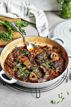 a large pot filled with stew on top of a table