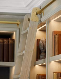 a ladder is attached to the side of a bookshelf